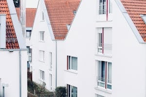 White houses with red roofs create a clean and modern suburban landscape.
